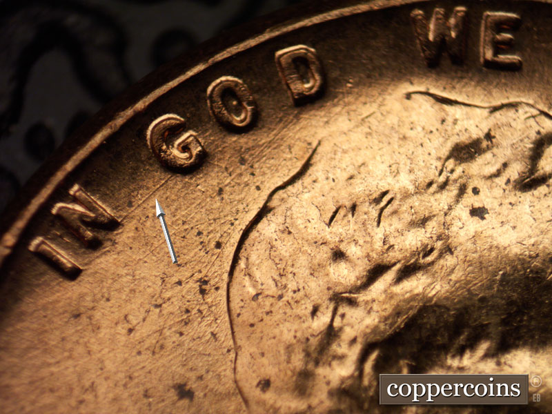 Die-stage B marker on 1960D•1MM•012 showing NE die scratch connect N of IN to G of GOD.