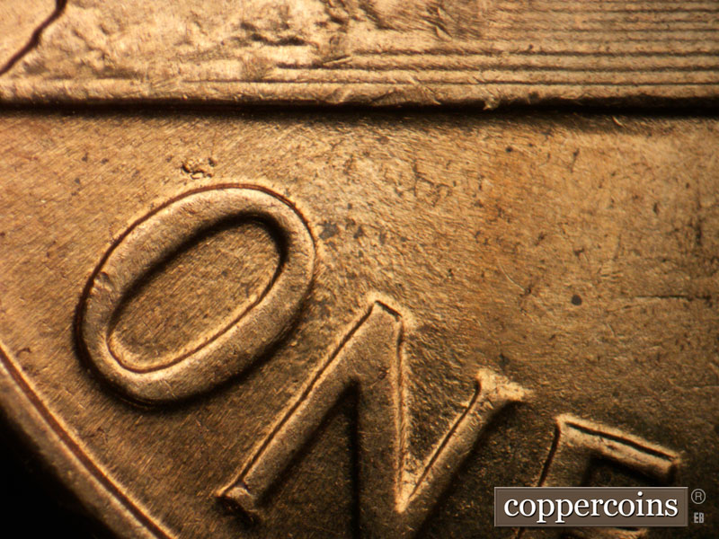 Die-stage B marker on 1960D•1MM•013 showing Pair of NE die scratches from O in ONE to base.