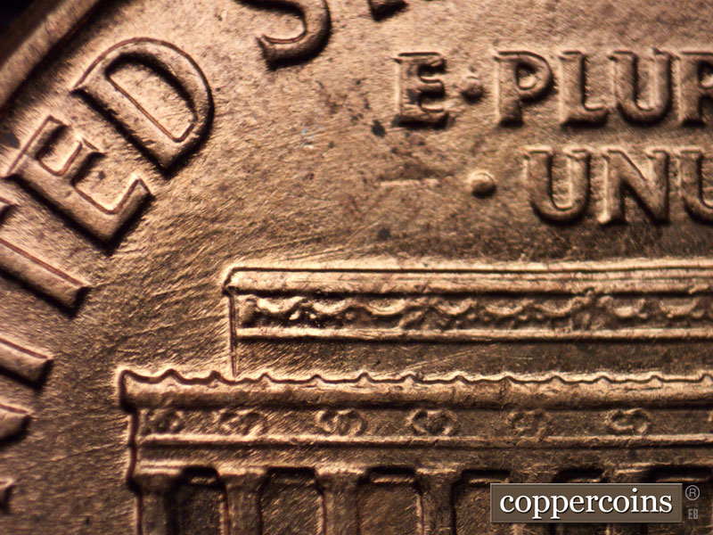 Die-stage C marker on 1960D•1MM•013 showing ENE die scratches from TE in UNITED through left roof.