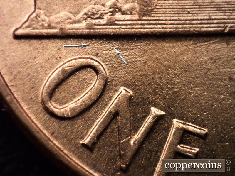 Die-stage C marker on 1960D•1MM•013 showing Pair of NE die scratches from O in ONE to base.