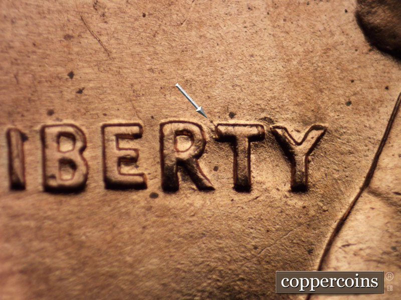 Die-stage B marker on 1960D•1MM•014 showing A few small die gouges on RT of LIBERTY.