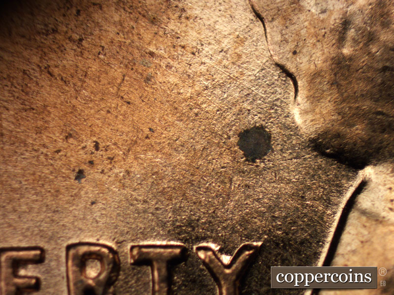 Die-stage A marker on 1960D•1MM•015 showing Light NW die scratches behind hair.