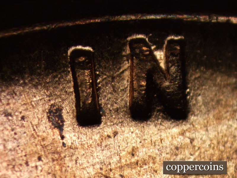 Die-stage A marker on 1960D•1MM•015 showing Die scratch through IN.