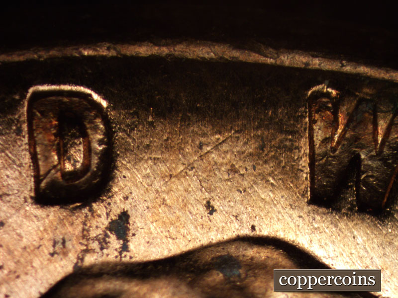 Die-stage A marker on 1960D•1MM•015 showing SW die scratch between D in GOD and W in WE.