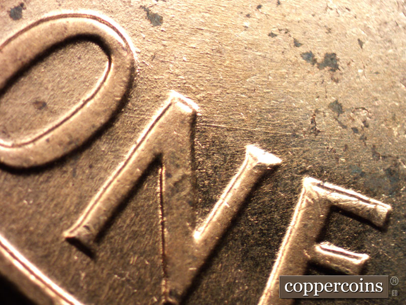 Die-stage A marker on 1960D•1MM•015 showing E/W die scratch through N in ONE.