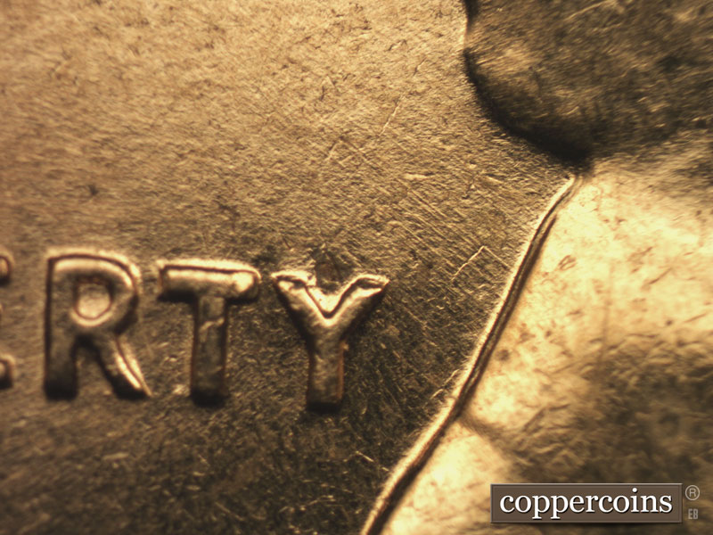 Die-stage B marker on 1960D•1MM•016 showing Light NW die scratches above Y in LIBERTY.