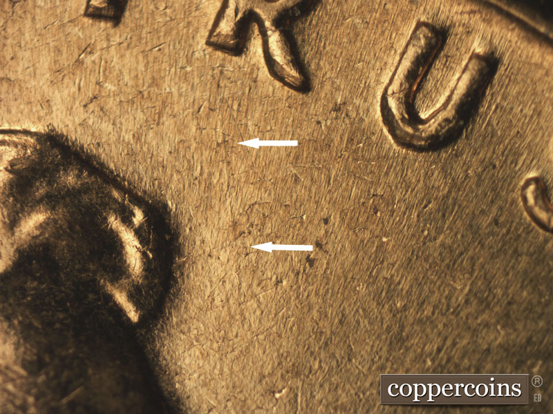 Die-stage B marker on 1960D•1MM•016 showing Light SSE die scratch from R in TRUST.