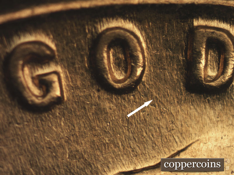 Die-stage B marker on 1960D•1MM•016 showing SE die scratch from O in GOD toward hair.