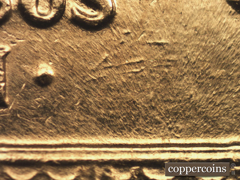 Die-stage B marker on 1960D•1MM•016 showing Numerous die gouges SE of S in PLURIBUS.