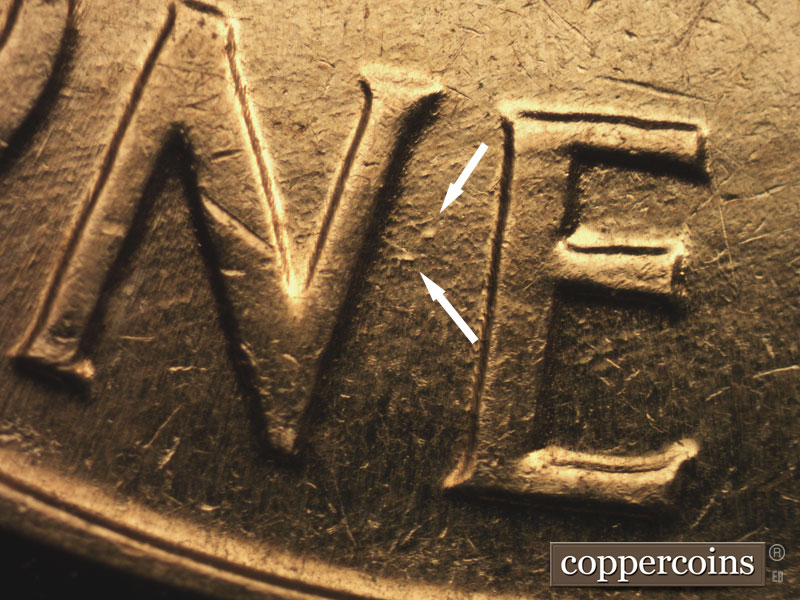 Die-stage B marker on 1960D•1MM•016 showing Die dots between N and E in ONE.