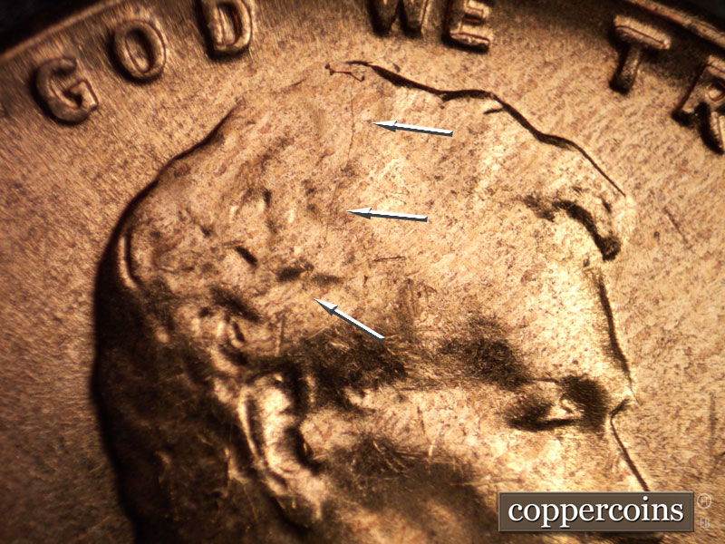 Die-stage C marker on 1960D•1MM•016 showing Die crack from ear toward WE.