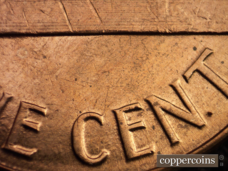 Die-stage C marker on 1960D•1MM•016 showing Light die pitting between CE in CENT.