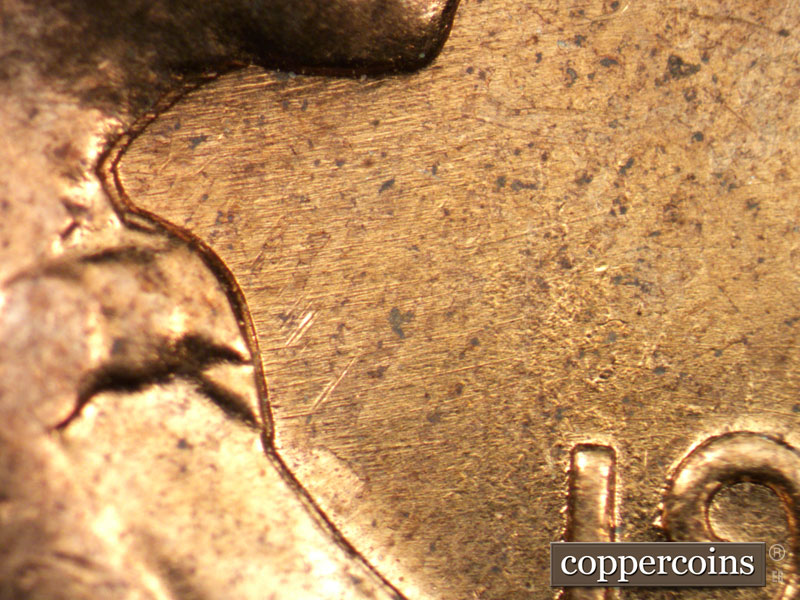 Die-stage A marker on 1960D•1MM•017 showing Light E/W die scratches through date and from bowtie area.