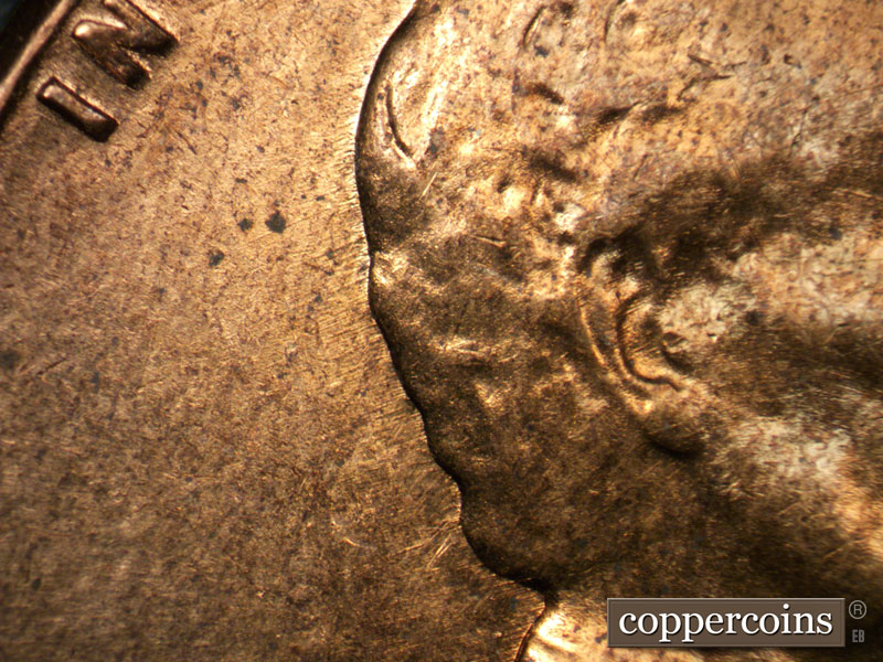 Die-stage A marker on 1960D•1MM•017 showing Short ESE die scratches from back of head.