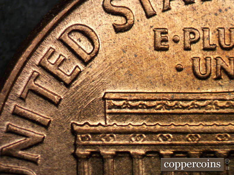 Die-stage A marker on 1960D•1MM•017 showing NE die scratches under ED in UNITED.