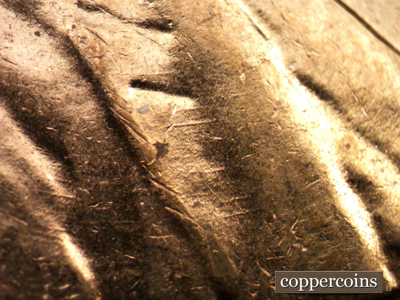 Die-stage C marker on 1960D•1MM•017 showing Concentric die scratches on lapel.