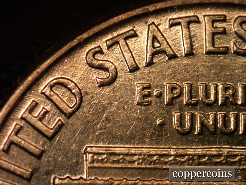 Die-stage C marker on 1960D•1MM•017 showing Crossing die scratches through UNITED STATES. N/S die scratches from left base.