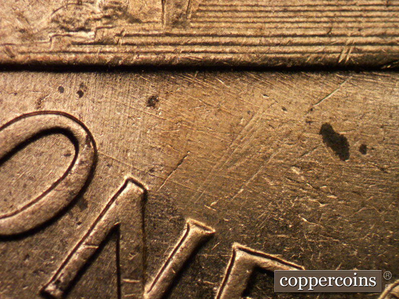 Die-stage C marker on 1960D•1MM•017 showing Heavy ESE die scratch from O in ONE.