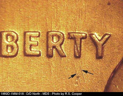 Die-stage B marker on 1960D•1MM•018 showing Die scratches through LIBERTY flowing N-S with a pair below T.