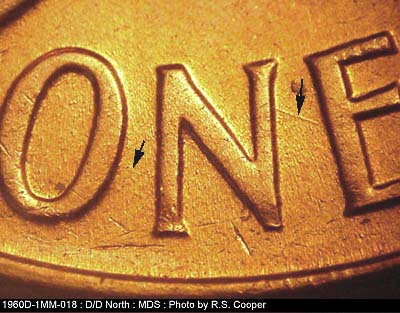 Die-stage B marker on 1960D•1MM•018 showing Two die scratches between the letters on ONE. One medium and one very light.