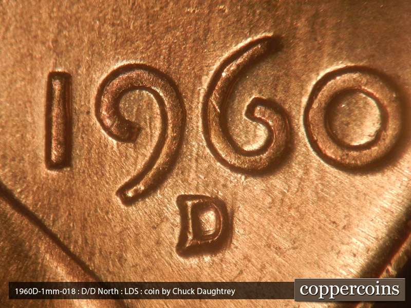 Die-stage C marker on 1960D•1MM•018 showing emnants of old die scratches run north from the top of the mint mark between the 9 & 6.
