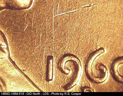 Die-stage C marker on 1960D•1MM•019 showing N/S die scratch above 1 in date.