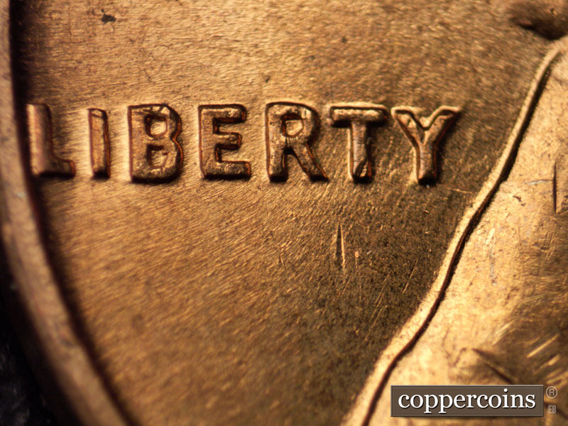 Die-stage B marker on 1960D•1MM•020 showing Week NNE die scratches through RTY in LIBERTY.