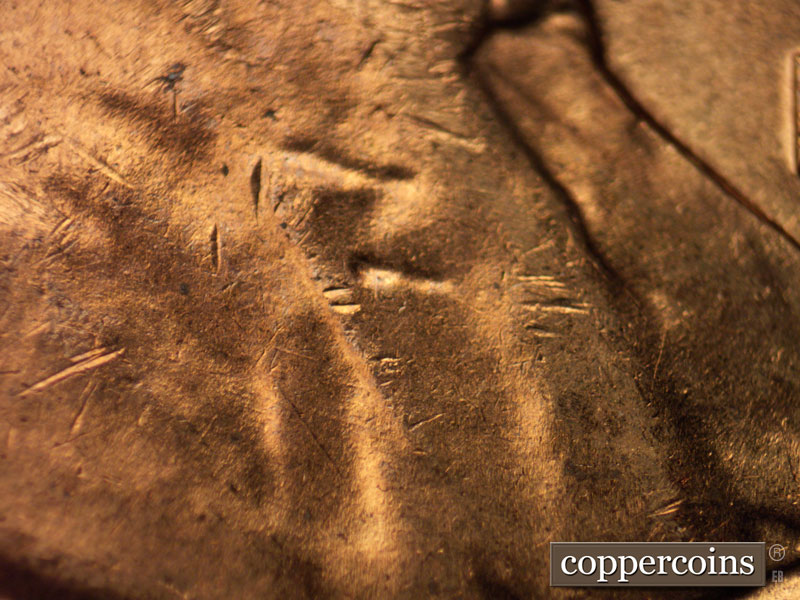 Die-stage B marker on 1960D•1MM•020 showing Light concentri die scratches across jacket.