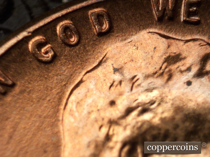 Die-stage C marker on 1960D•1MM•020 showing Die dot in O of GOD.