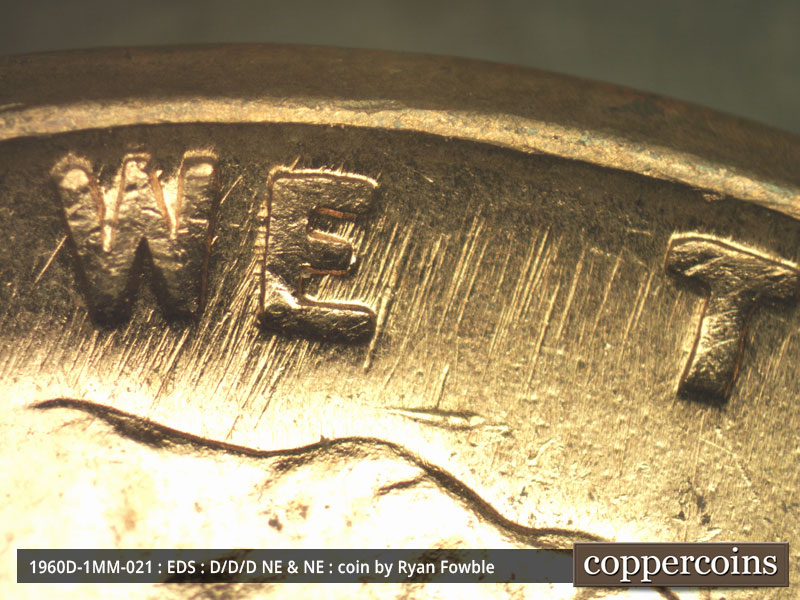 Die-stage A marker on 1960D•1MM•021 showing Generally SSW/NNE die scratches show in WE TRUST.