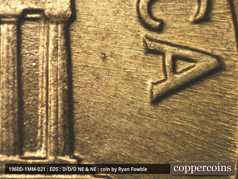 Die-stage A marker on 1960D•1MM•021 showing E/W die scratches from column 12 through A in AMERICA.