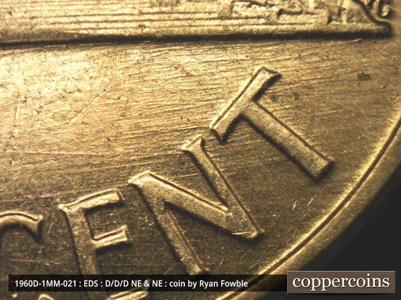 Die-stage A marker on 1960D•1MM•021 showing E/W die scratches under base and through CENT.