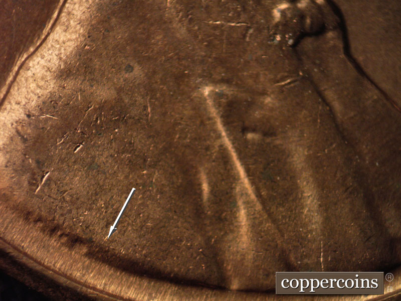 Die-stage B marker on 1960D•1MM•021 showing A short and light die crack shows in VDB on the shoulder.
