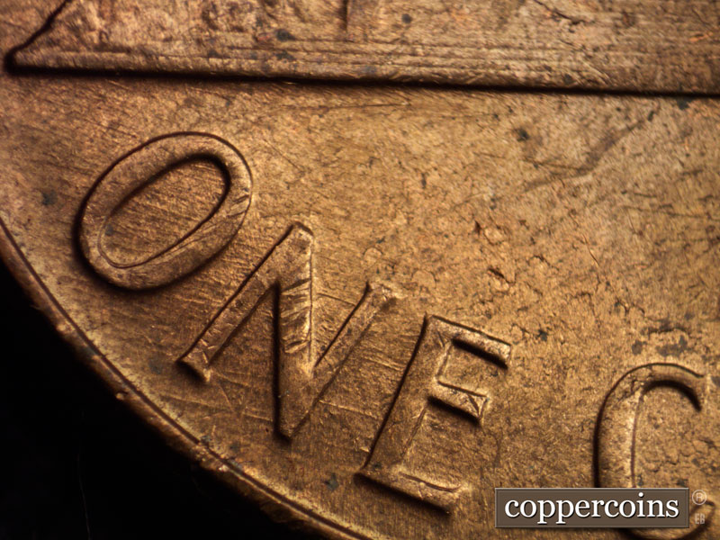 Die-stage B marker on 1960D•1MM•021 showing ESE die scratches through ONE.