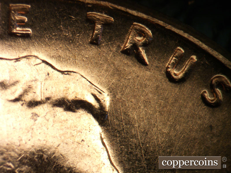 Die-stage B marker on 1960D•1MM•022 showing Intersecting die scratches under TRUST.
