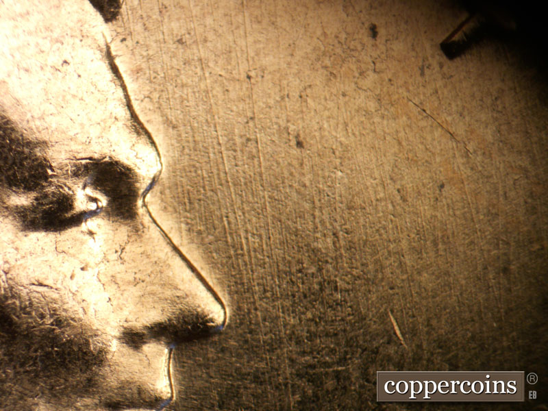 Die-stage B marker on 1960D•1MM•022 showing N/S die scratches in front of nose.
