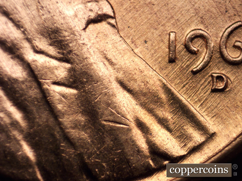 Die-stage A marker on 1960D•1MM•023 showing SW die scratches through date.