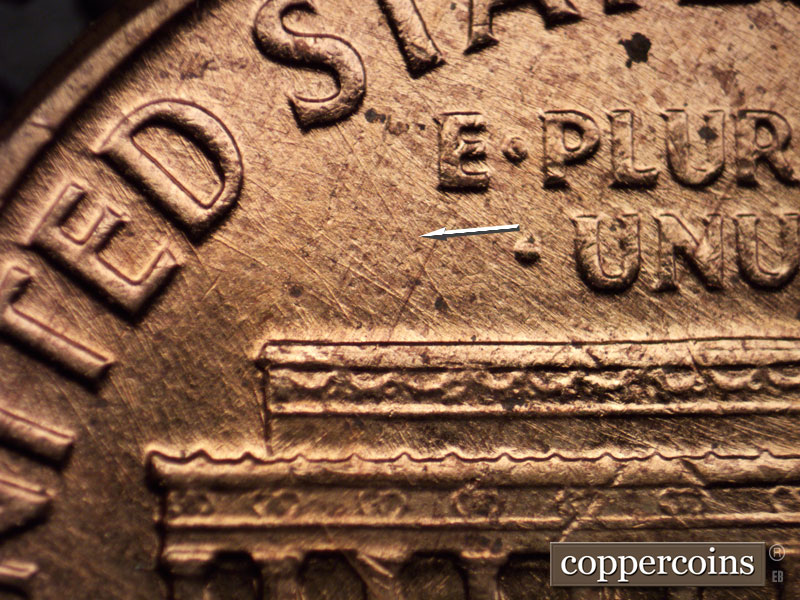 Die-stage A marker on 1960D•1MM•023 showing NW sie scratch from roof to first S in STATES.