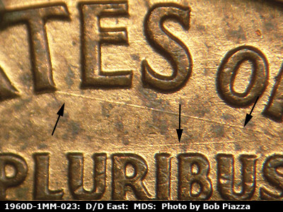 Die-stage B marker on 1960D•1MM•023 showing A heavy die scratch under TES OF. A heavy die scratch above PLURIBUS.