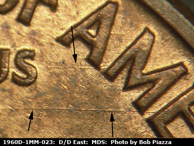 Die-stage B marker on 1960D•1MM•023 showing E/W die scratches through UNUM all the way to the ME of AMERICA.