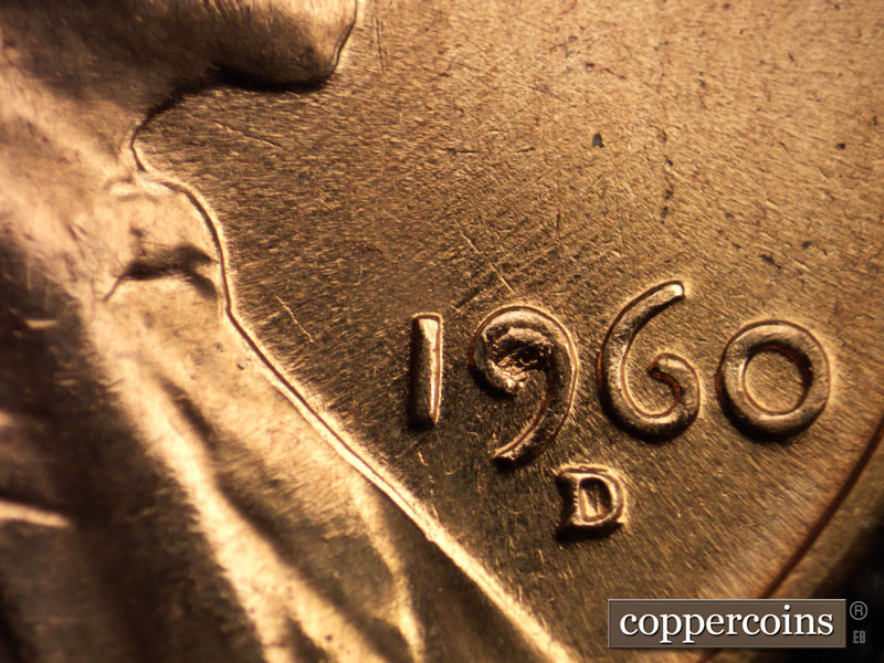 Die-stage C marker on 1960D•1MM•025 showing NE die scratches through date. Die break fills upper loop of 9 in date.
