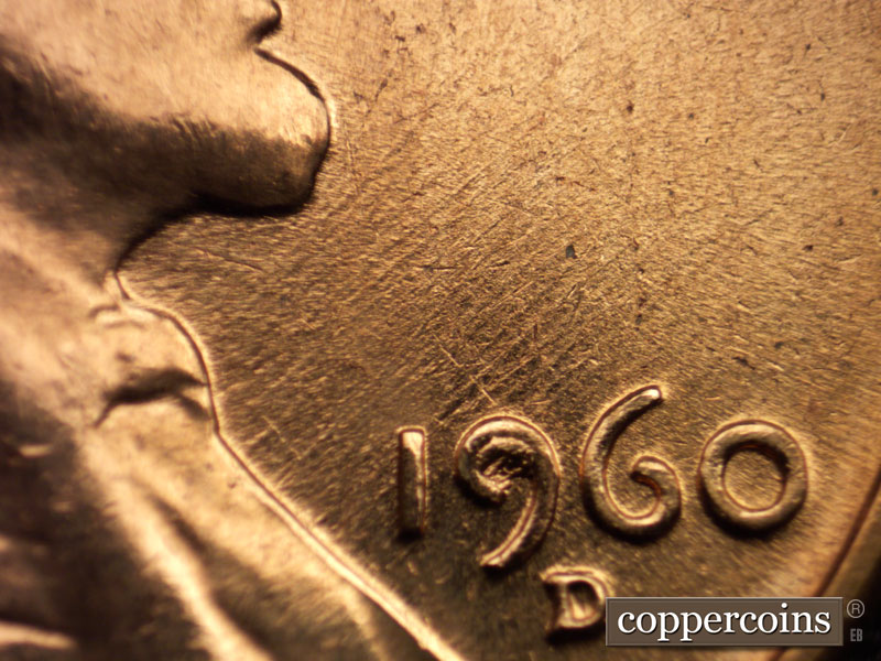 Die-stage C marker on 1960D•1MM•025 showing NE die scratches through date.