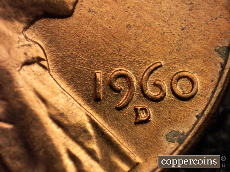 Die-stage A marker on 1960D•1MM•027 showing NNE die scratch from lapel through 1 to 9 in date.