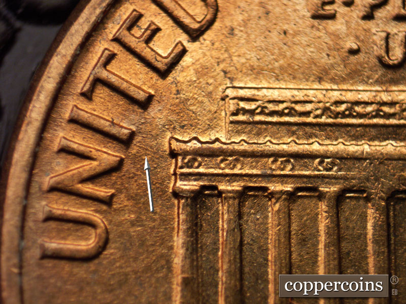 Die-stage A marker on 1960D•1MM•027 showing Short ENE die scratch from left cornice to I in UNITED.