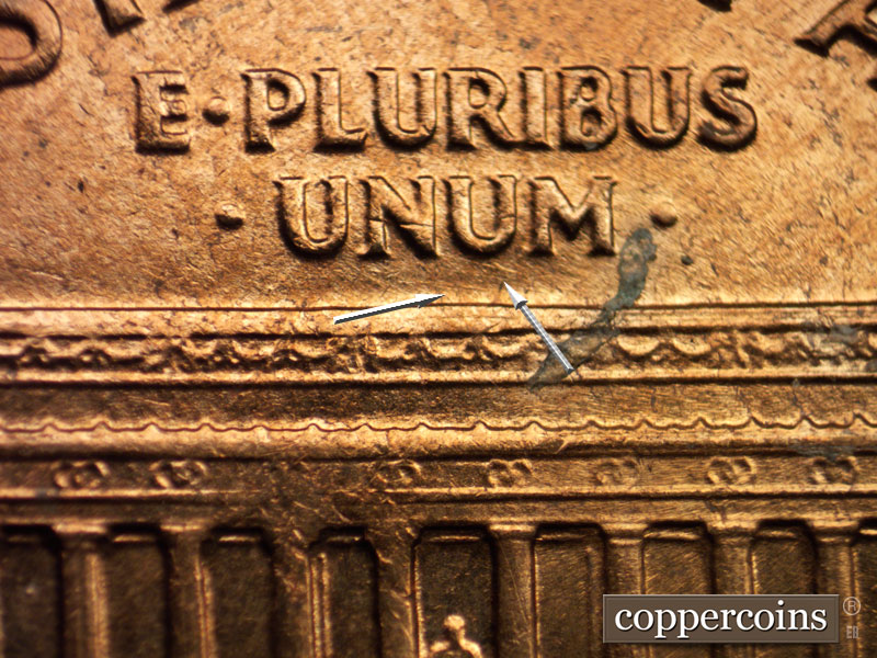 Die-stage A marker on 1960D•1MM•027 showing A pair of ESE die scratches under NU in UNUM.