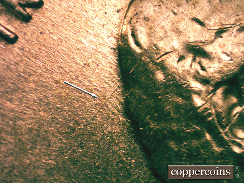 Die-stage B marker on 1960D•1MM•027 showing SW die scratch from back of hair.