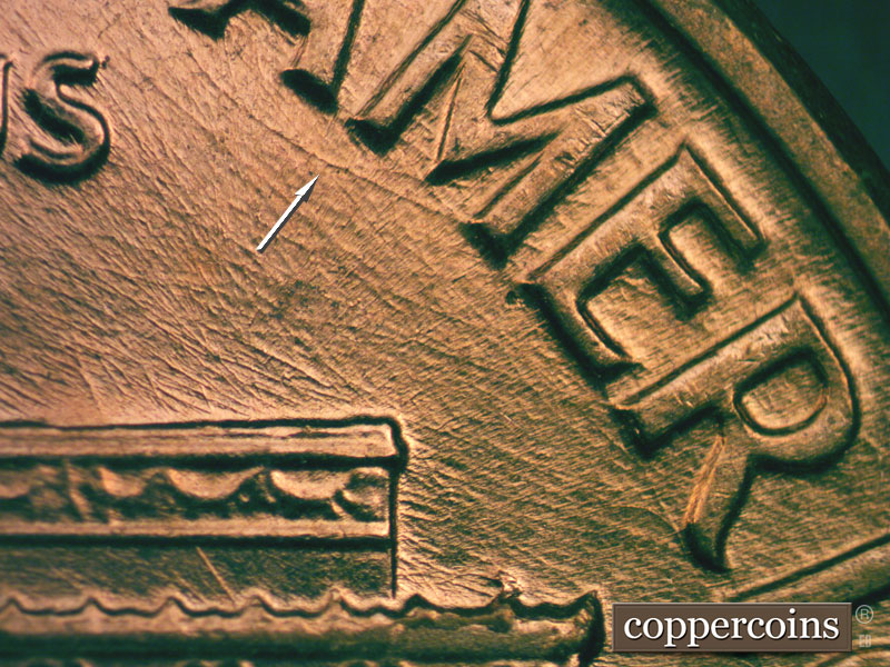 Die-stage B marker on 1960D•1MM•027 showing Heavy curved die scratch connect A to M in AMERICA.