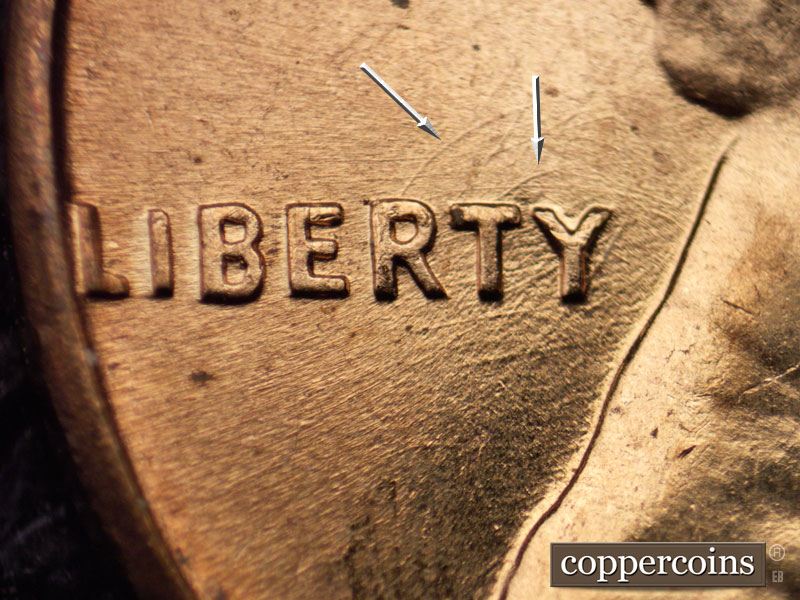 Die-stage A marker on 1960D•1MM•028 showing Curved die scratches from R and T in LIBERTY.