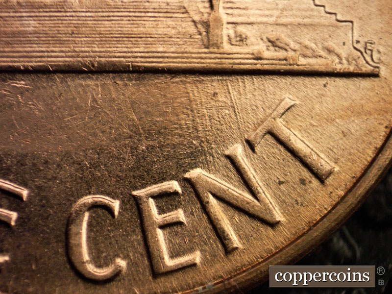 Die-stage A marker on 1960D•1MM•028 showing SSE die scratches from right base through NT in CENT.