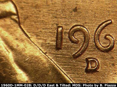 Die-stage B marker on 1960D•1MM•028 showing E/W die scratches through date.